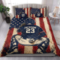Patriotic baseball quilt blanket styled on a bedroom bed with stars, stripes, and ballplayer artwork