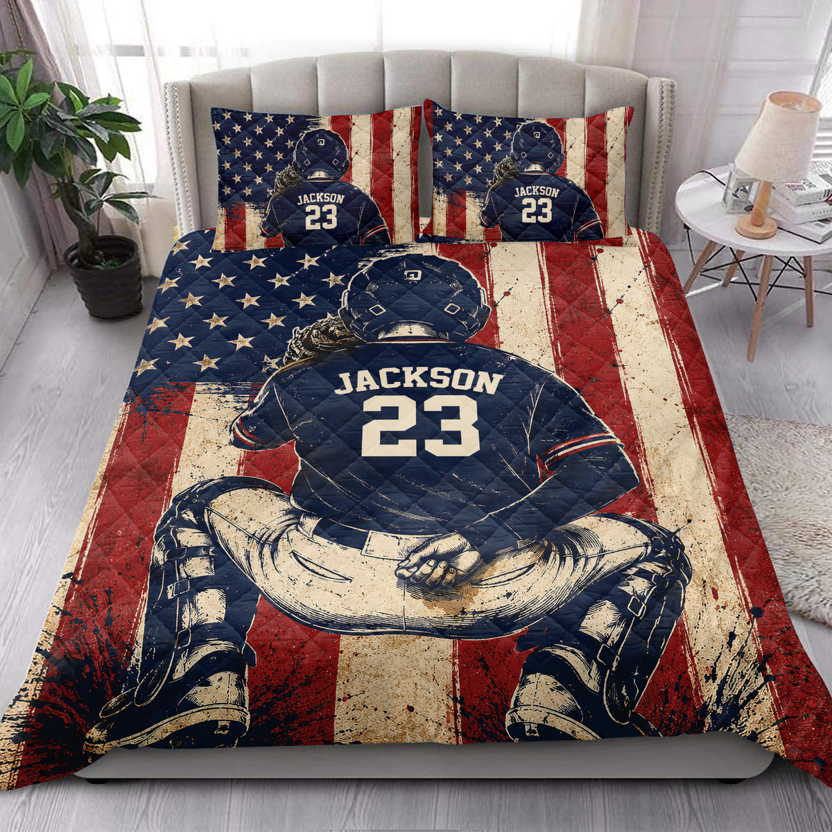 Patriotic baseball quilt blanket styled on a bedroom bed with stars, stripes, and ballplayer artwork