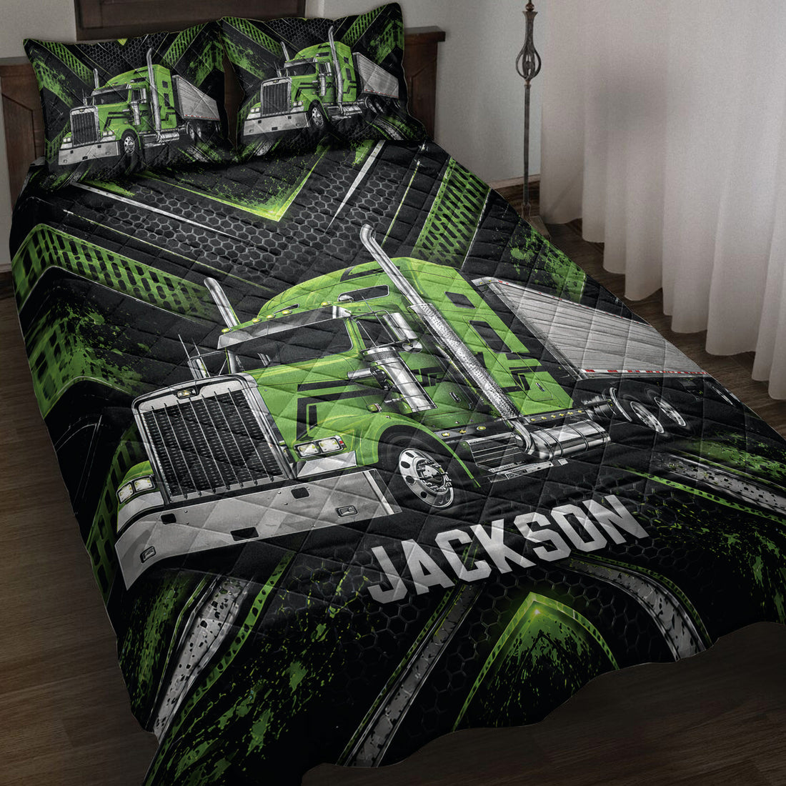 Green semi-truck quilt blanket displayed on a bed with black geometric trucker artwork