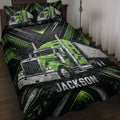 Green semi-truck quilt blanket displayed on a bed with black geometric trucker artwork