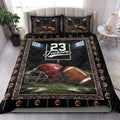 Football quilt blanket styled on a bedroom bed with helmet, football, goalpost, and stadium light artwork