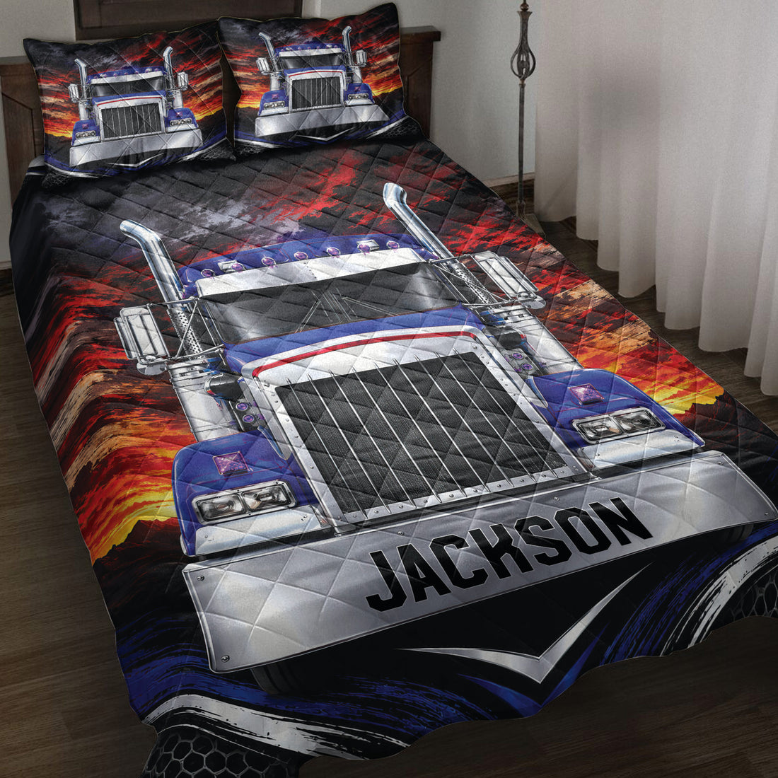 Trucker quilt blanket displayed on a bed with a bold blue semi-truck and fiery red mountain artwork