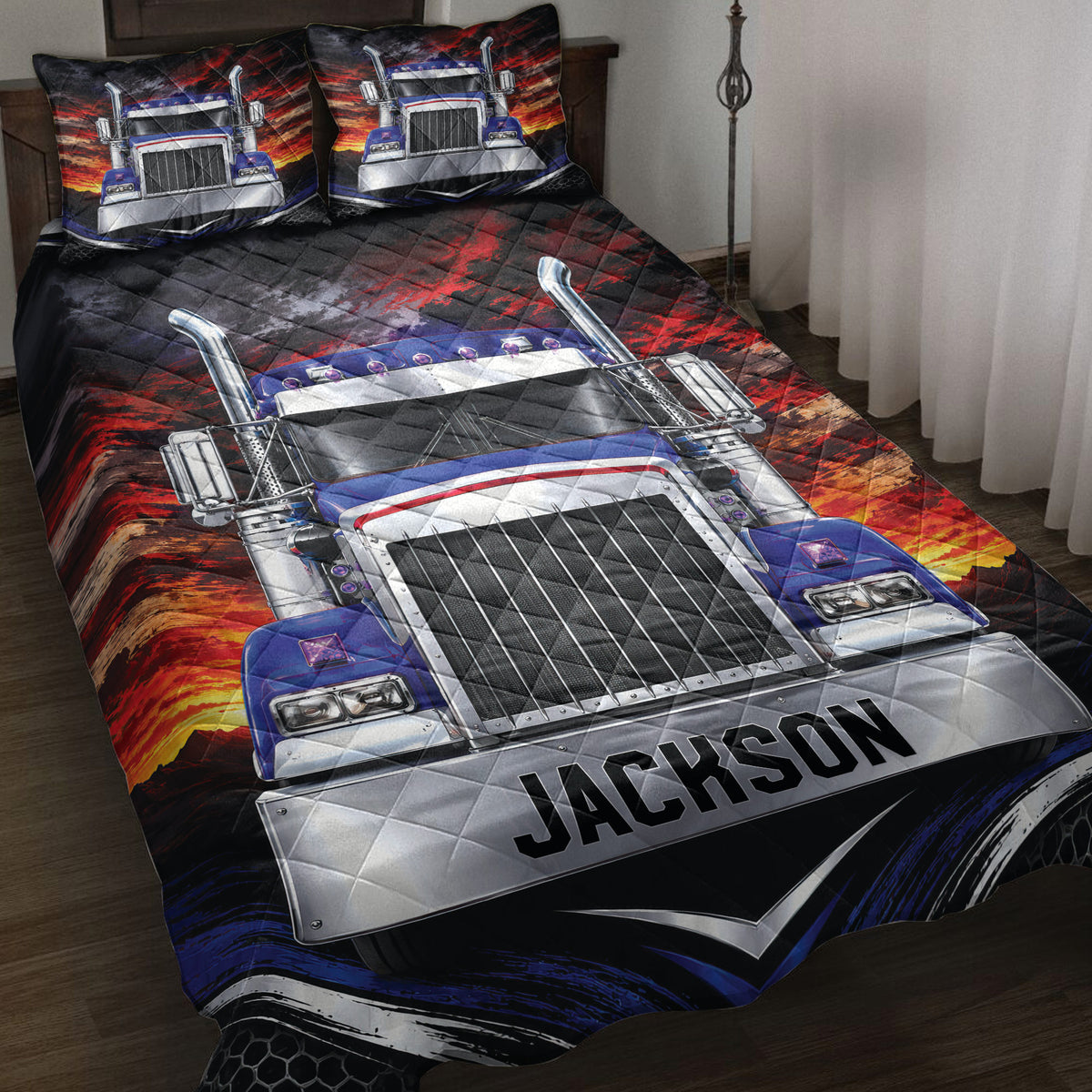 Trucker quilt blanket displayed on a bed with a bold blue semi-truck and fiery red mountain artwork