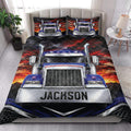 Trucker quilt blanket styled on a bedroom bed with a large semi-truck and dramatic sunset design