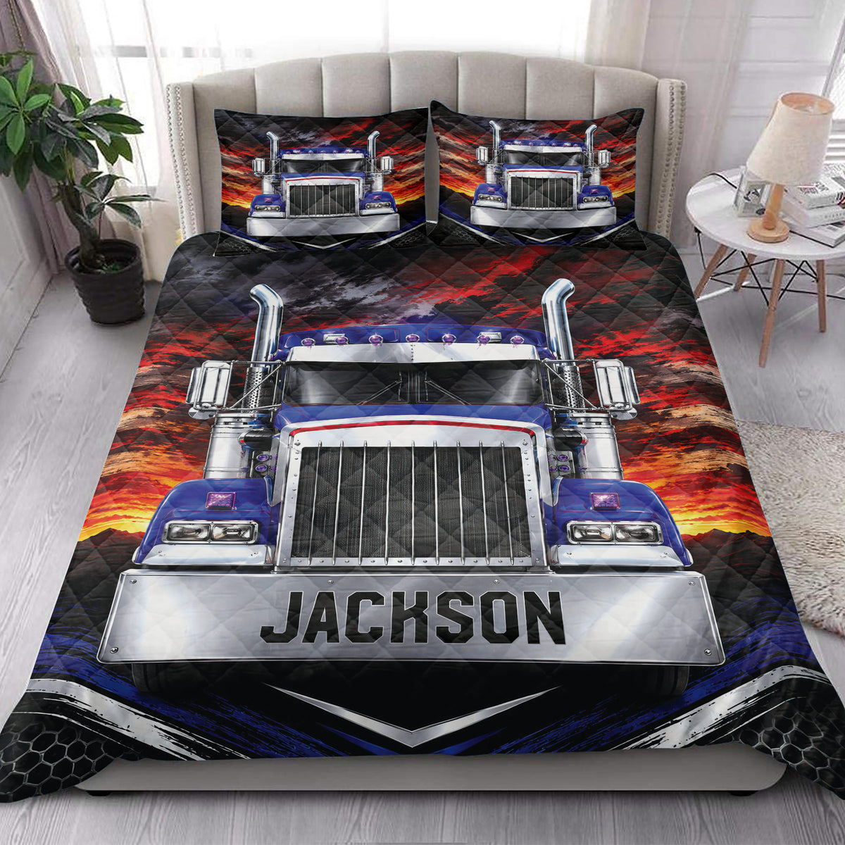 Trucker quilt blanket styled on a bedroom bed with a large semi-truck and dramatic sunset design