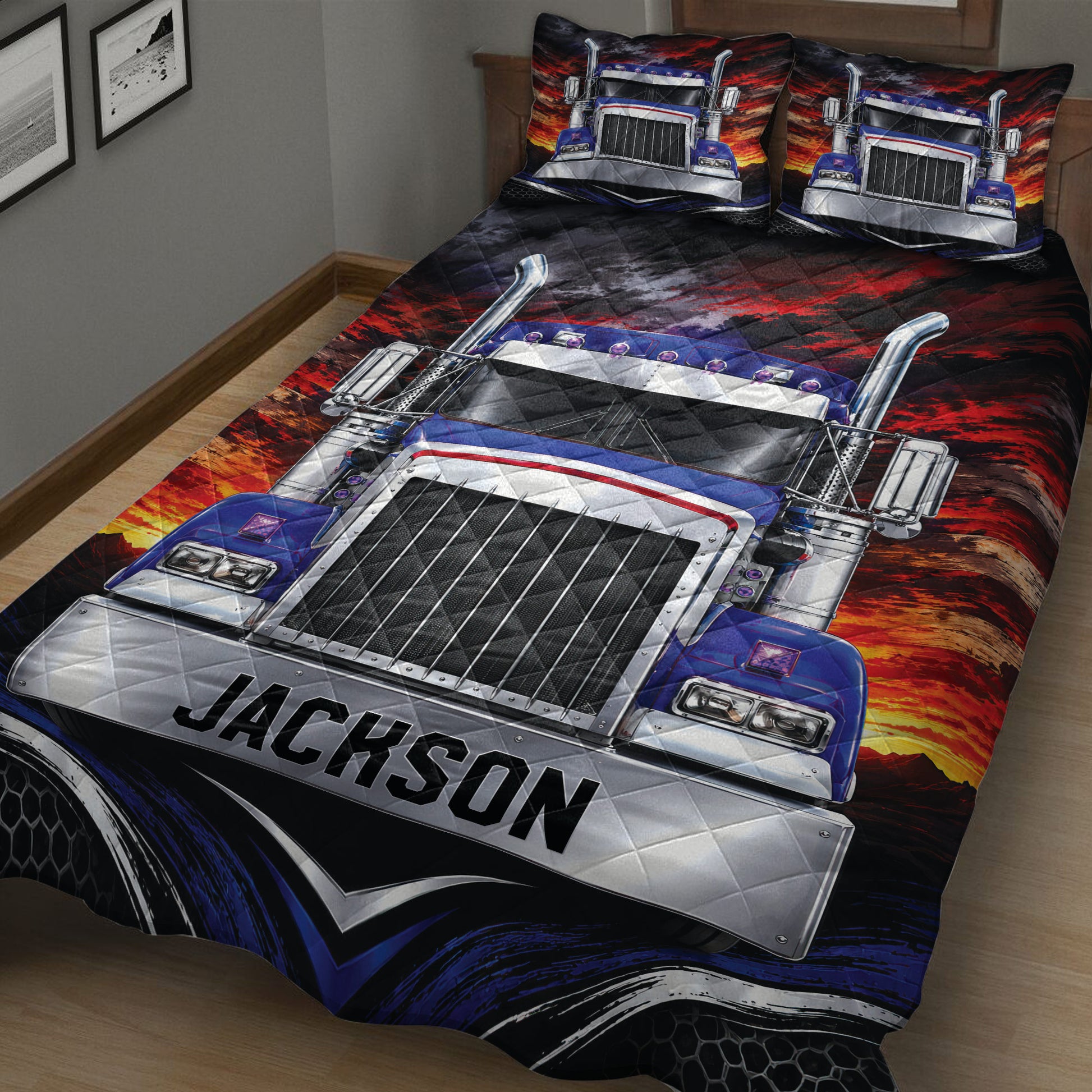 Angled bedroom view of a trucker quilt with detailed big rig artwork and dark red, blue, and black colors