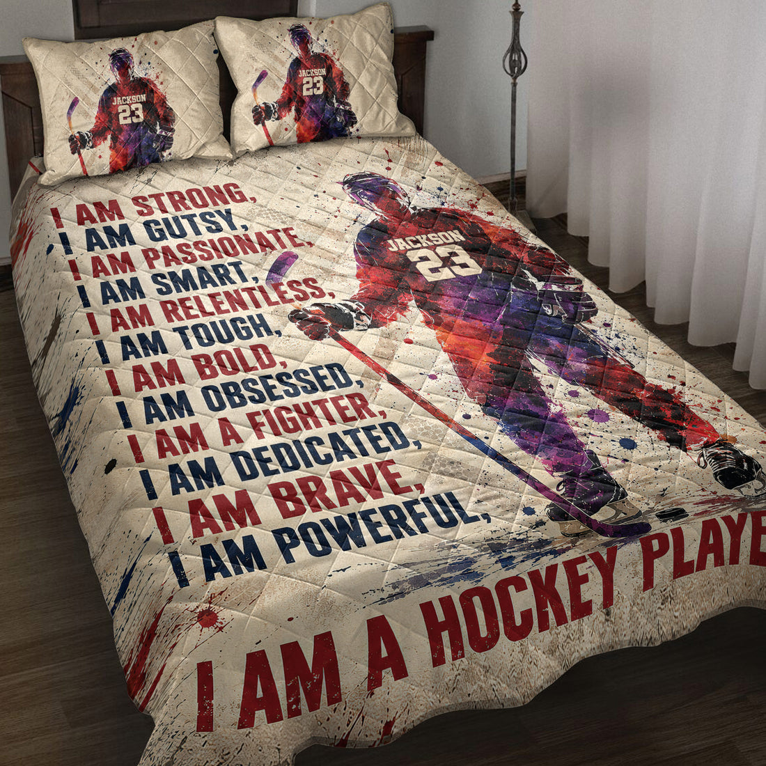 Hockey quilt blanket displayed on a bed with ice hockey player artwork and bold red and navy motivational design