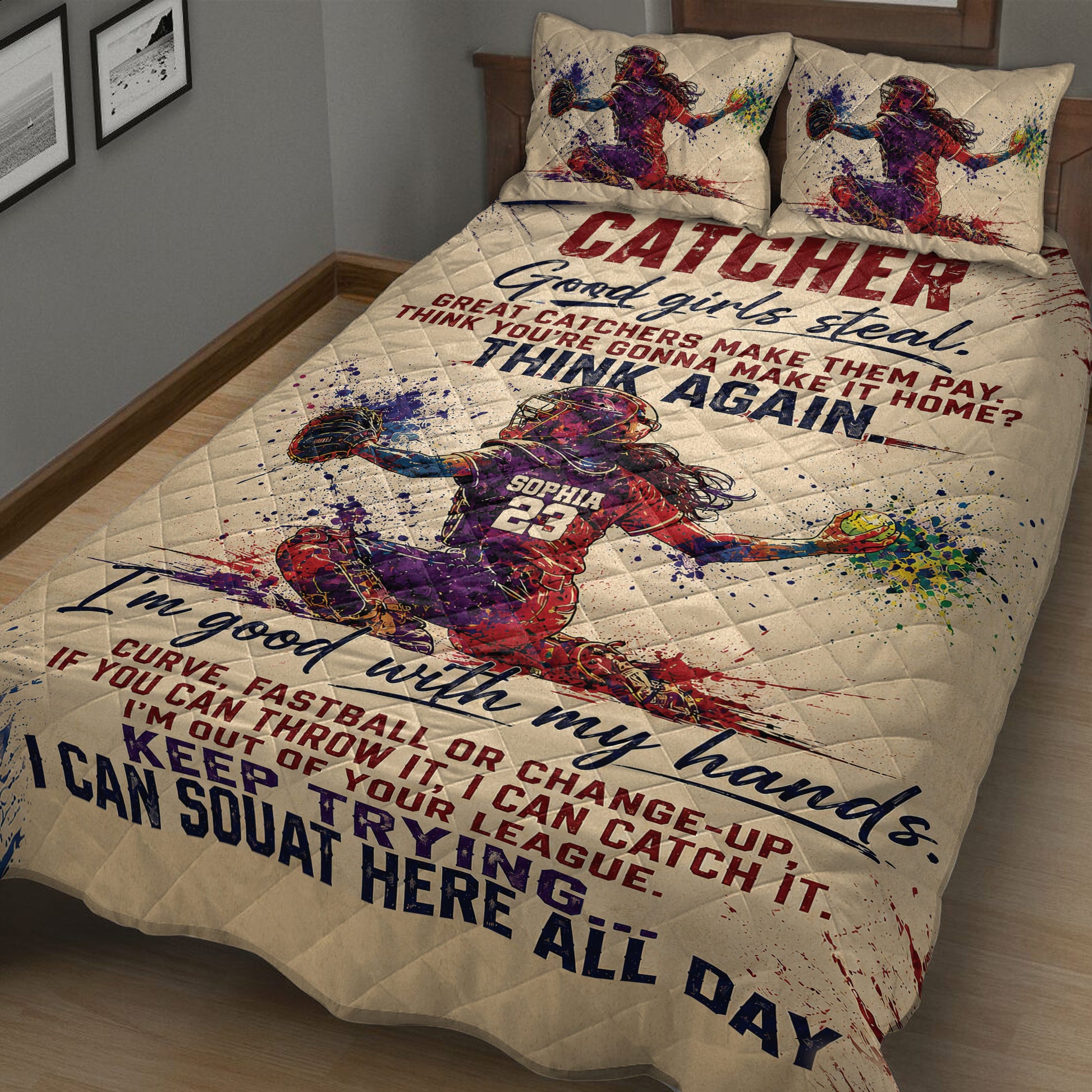 Softball catcher quilt blanket shown on a bedroom bed with vibrant red, blue, and purple artwork