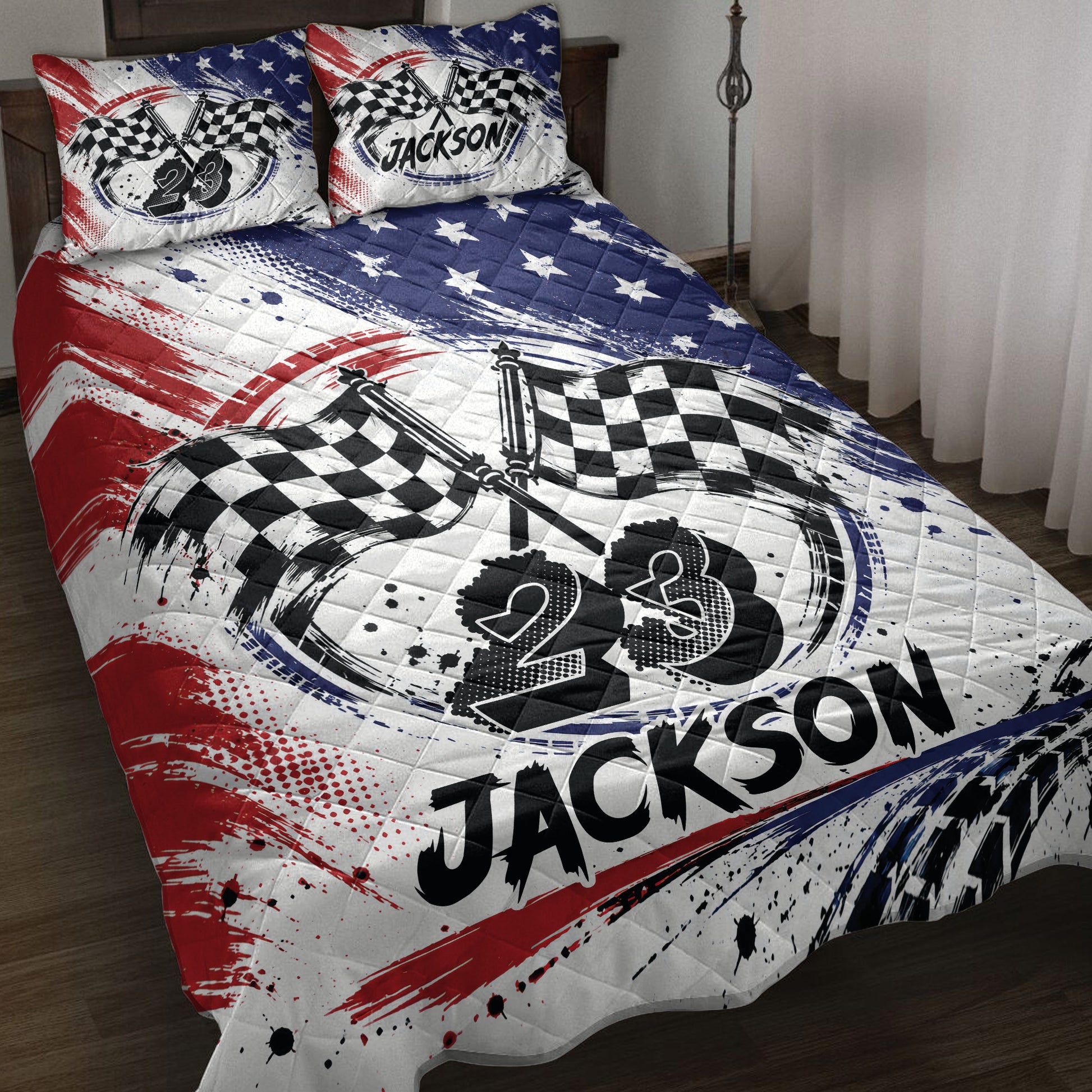 Racing quilt blanket displayed on a bed with crossed checkered flags and bold red, white, and blue artwork