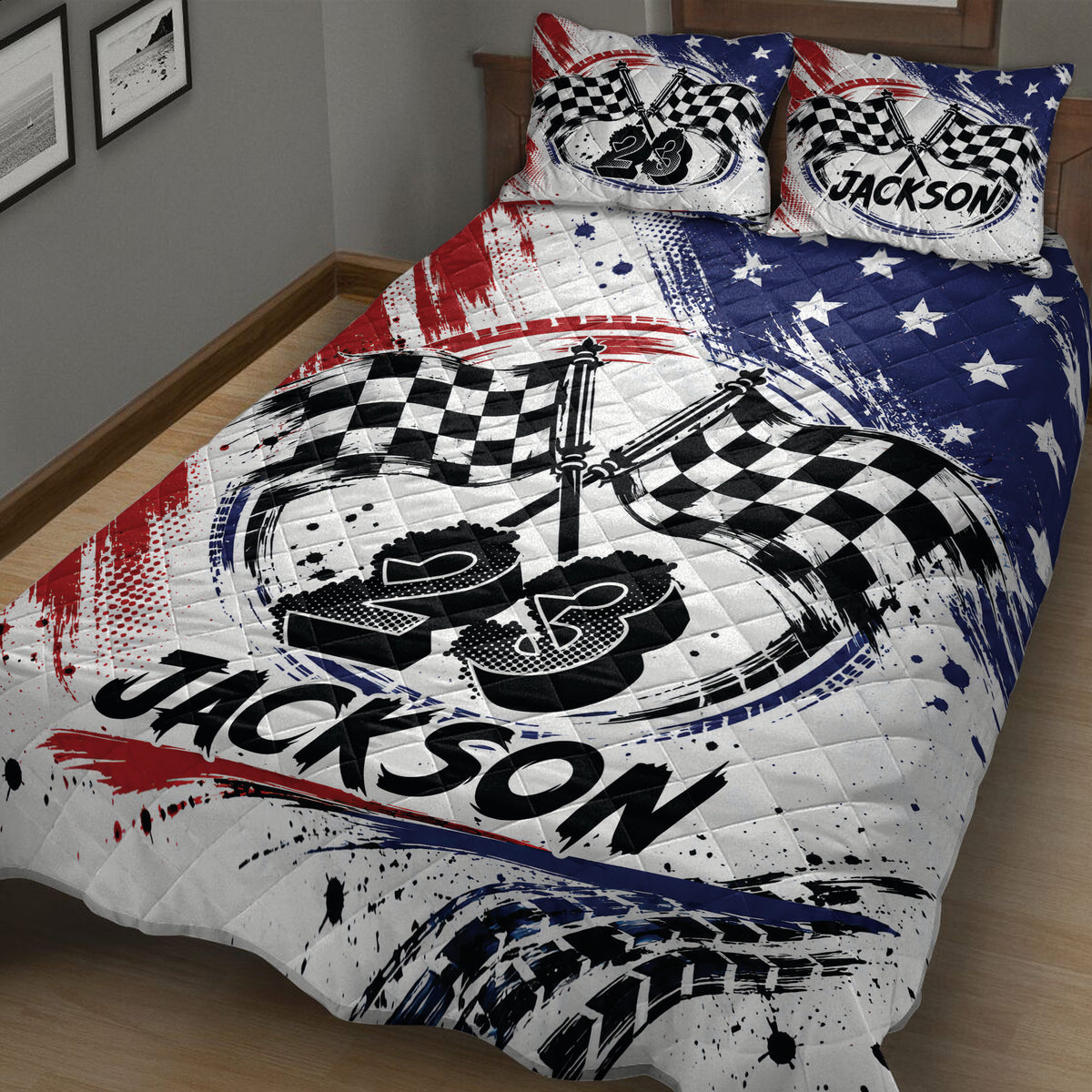 Close bedroom view of a racing quilt with crossed checkered flags and bold black, red, white, and blue artwork