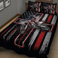 Close bedroom view of a black motocross quilt with red and white stripes, stars, and dirt bike rider artwork