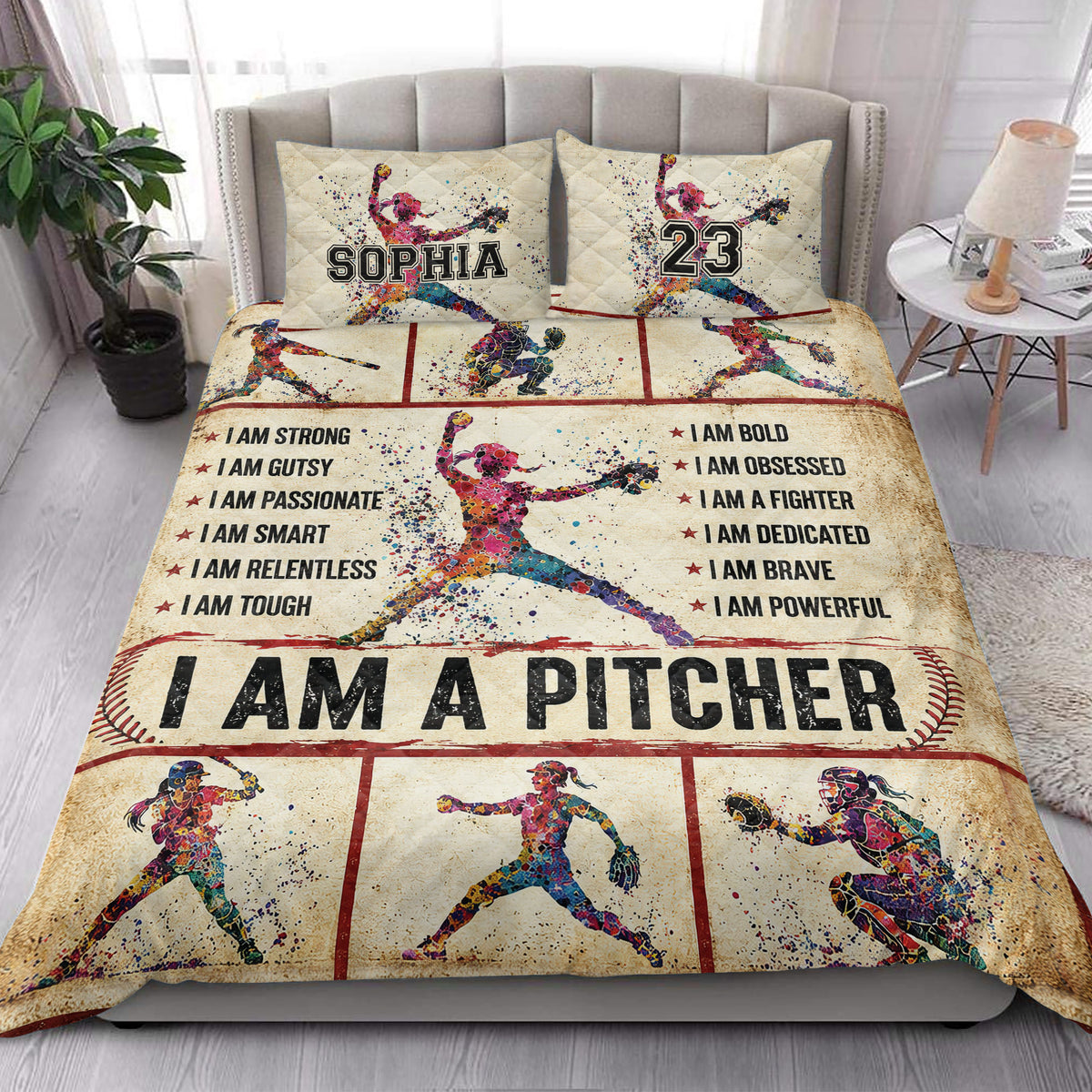 Softball quilt blanket styled on a bedroom bed with colorful player illustrations, baseball stitching, and motivational typography