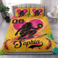 Softball quilt bedding styled in a bedroom with bold yellow, pink, and black catcher artwork