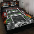 Trucker quilt blanket displayed on a bed with green semi truck artwork and dramatic black and red sunset design