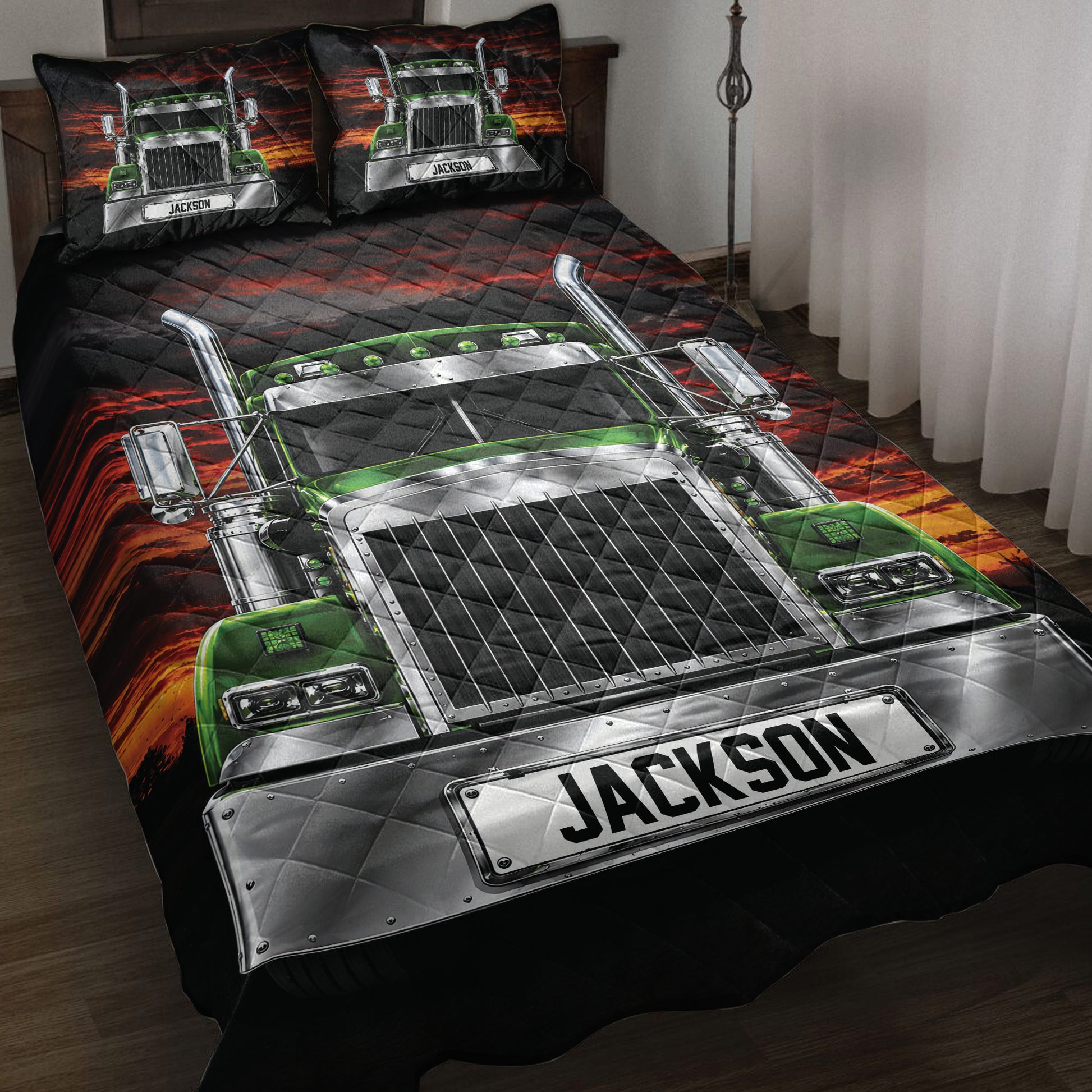 Trucker quilt blanket displayed on a bed with green semi truck artwork and dramatic black and red sunset design