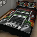 Close bedroom view of a black and red semi truck quilt blanket with bold green truck artwork