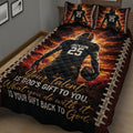 Close view of an American football quilt blanket featuring a helmeted player, fiery background, and motivational artwork