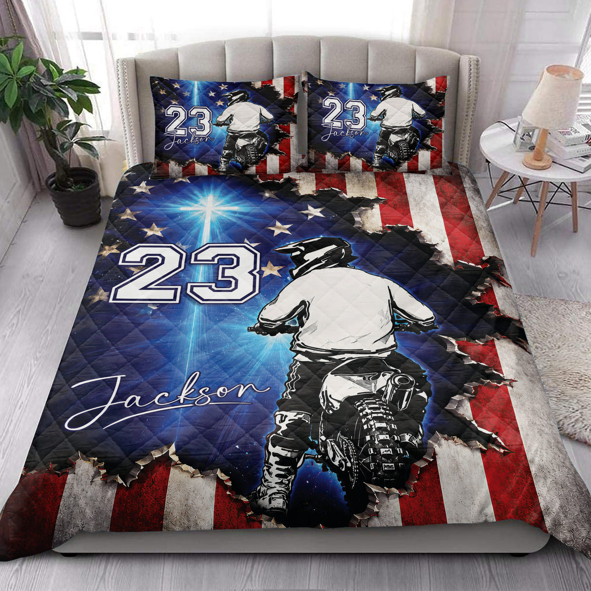 Motocross quilt bedding styled in a bedroom with dirt bike rider artwork and bold red white blue accents