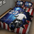 Close bedroom view of a motocross quilt blanket featuring a dirt bike rider, stars, and patriotic striping