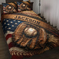 Baseball quilt blanket displayed on a bed with gloves, baseballs, stars, and vintage patriotic artwork