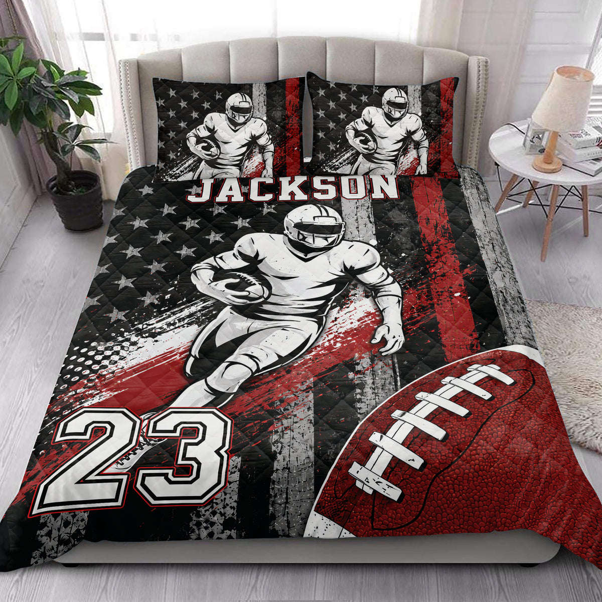 Football quilt bedding styled in a bedroom with bold red, black, and white sports artwork
