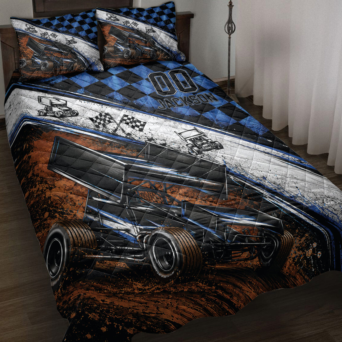 Dirt track racing quilt blanket displayed on a bed with sprint cars, checkered flags, and blue black artwork
