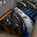 Close bedroom view of a dirt track racing quilt with sprint cars, racing flags, and blue black checkered pattern