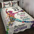 Colorful softball player quilt blanket displayed on a bed with bold sports artwork and motivational design