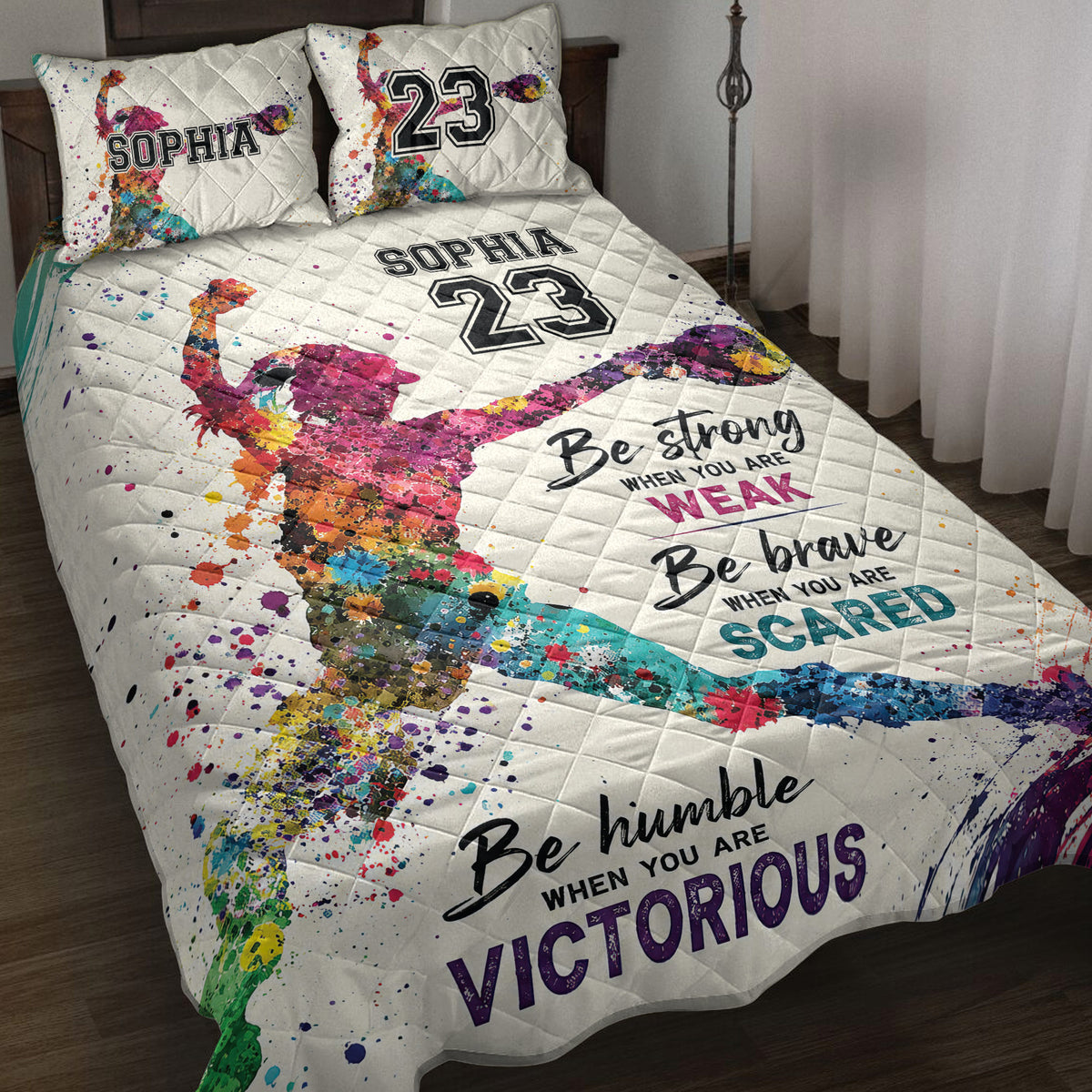 Colorful softball player quilt blanket displayed on a bed with bold sports artwork and motivational design