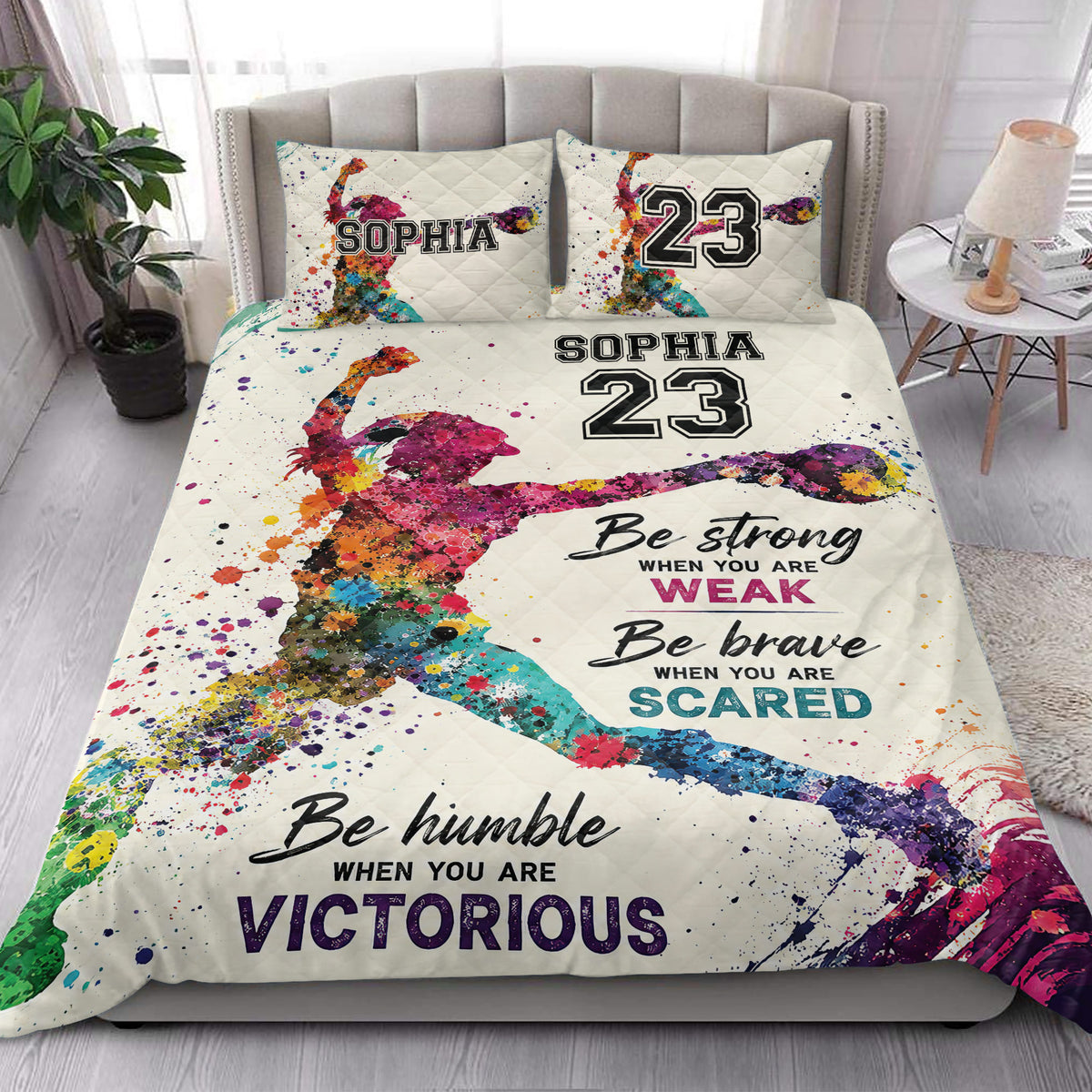Colorful softball player quilt blanket styled in a bright bedroom with matching sports artwork