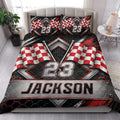 Racing quilt blanket styled in a bright bedroom with checkered flags and bold black, red, and silver graphics