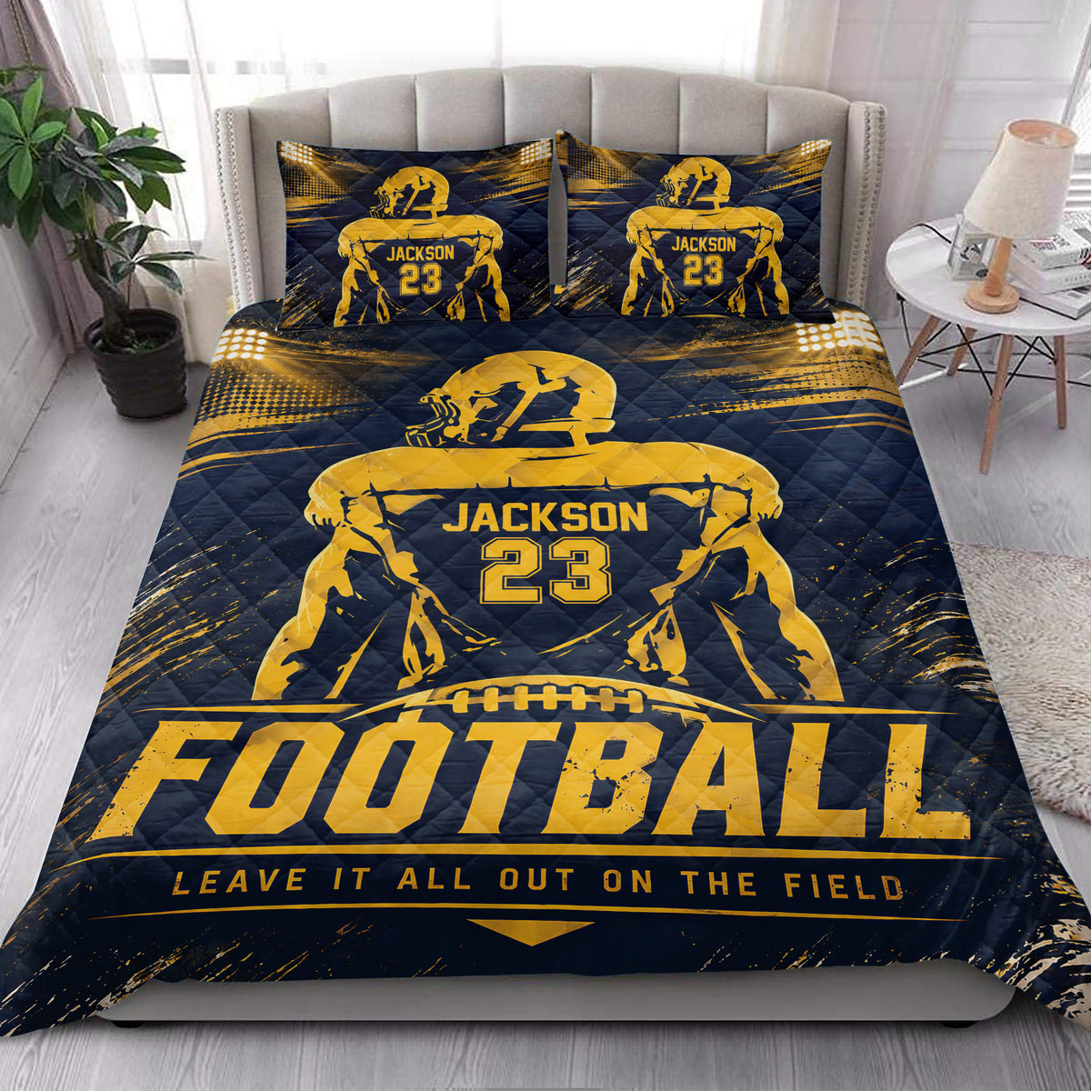 Football-themed quilt bedding styled in a bright bedroom with navy and gold sports artwork