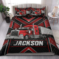 Trucker quilt bedding styled on a bedroom bed with red semi-truck artwork and bold black geometric design