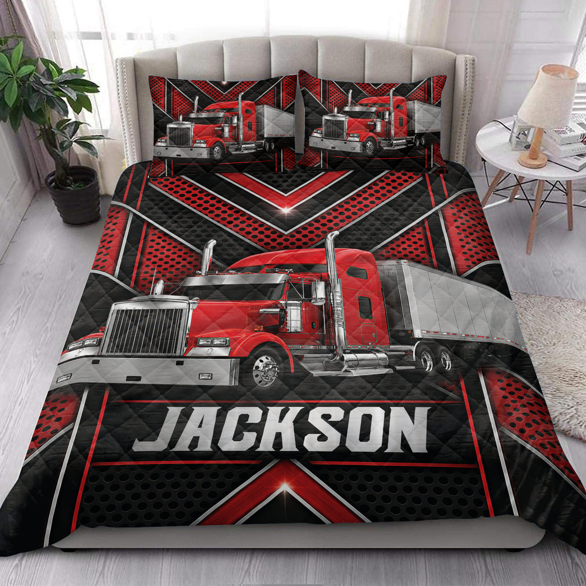 Trucker quilt bedding styled on a bedroom bed with red semi-truck artwork and bold black geometric design