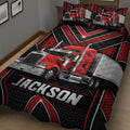 Close view of a trucker quilt blanket featuring a red semi truck, silver trailer, and black red pattern