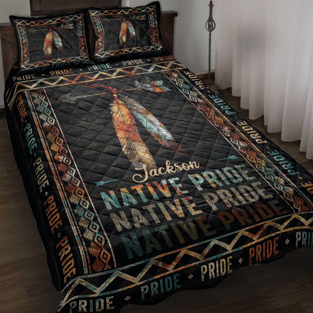 Native Pride quilt blanket displayed on a bed with colorful feathers, arrows, geometric borders, and dark artwork