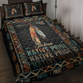 Native Pride quilt blanket displayed on a bed with colorful feathers, arrows, geometric borders, and dark artwork