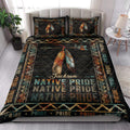 Native Pride quilt blanket styled in a bedroom with feather artwork, geometric motifs, and dark Southwestern colors