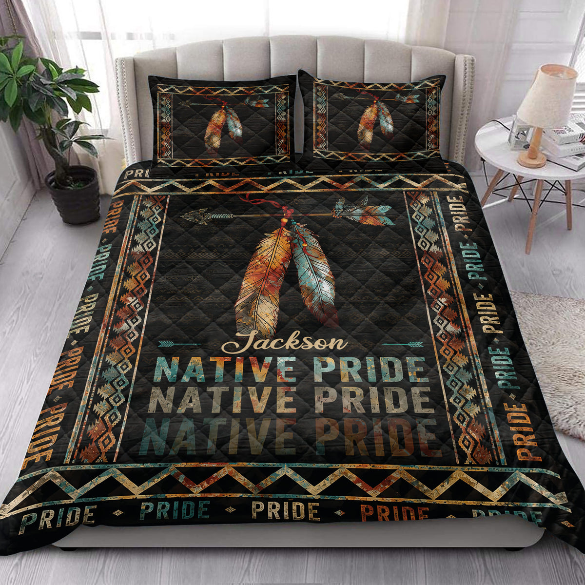 Native Pride quilt blanket styled in a bedroom with feather artwork, geometric motifs, and dark Southwestern colors
