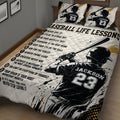 Close view of a baseball quilt blanket featuring a batter illustration, motivational sports messages, and gold accents