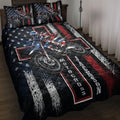 Motocross quilt blanket displayed on a bed with dirt bike rider artwork in black, red, white, and blue