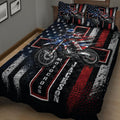 Close bedroom view of a motocross quilt blanket with dirt bike artwork and bold patriotic colors