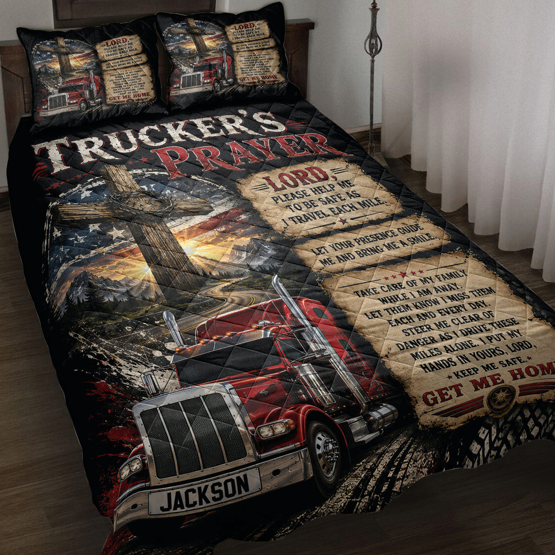 Trucker quilt blanket displayed on a bed with red semi-trucks, mountain roads, cross artwork, and prayer panels