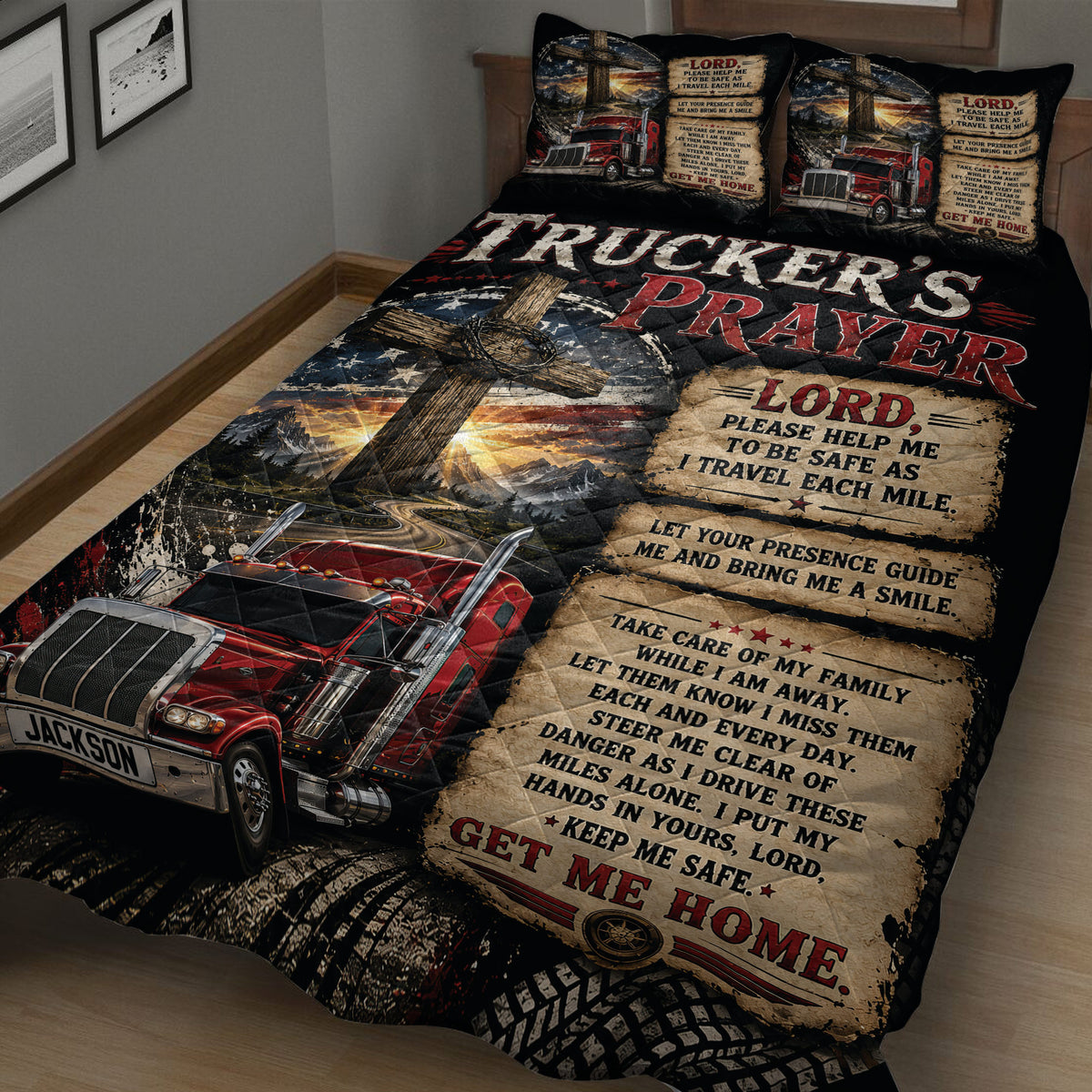 Close view of a black and red trucker quilt featuring a red semi-truck, mountain road, cross, and prayer artwork