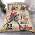 Softball quilt blanket styled on a bed with colorful player artwork and bold motivational sports lettering