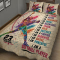 Close bedroom view of a colorful softball player quilt blanket with dynamic paint-splatter artwork