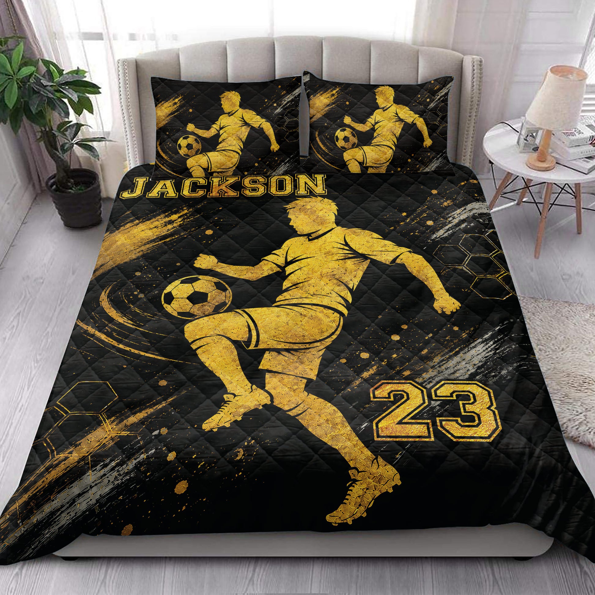 Soccer quilt blanket styled in a bright bedroom with bold black and gold player artwork