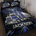 Blue semi-truck quilt blanket displayed on a bed with black and blue geometric detailing