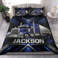 Trucker quilt blanket styled on a bedroom bed with blue semi-truck artwork and geometric borders