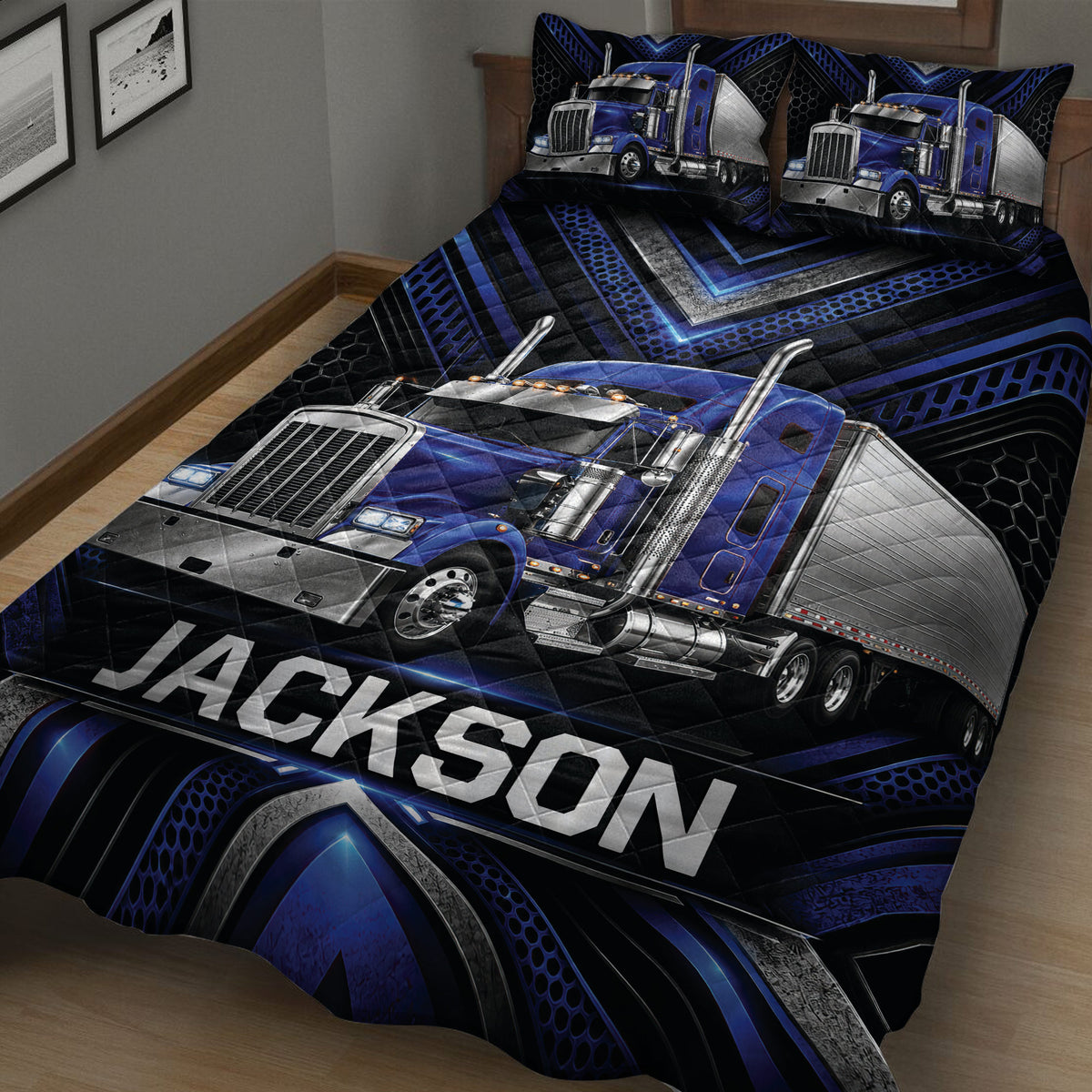 Close view of a black and blue trucker quilt blanket featuring a detailed blue semi-truck